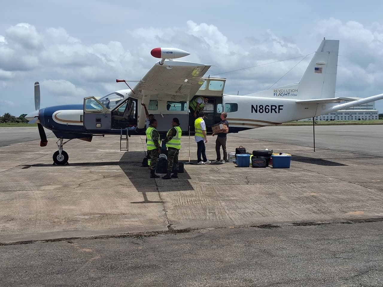 GoldCoast survey aircraft on the tarmac in Ghana with field team preparing for an airborne geophysical mission